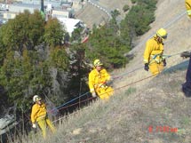 (Photo - firefighters climbing hill)