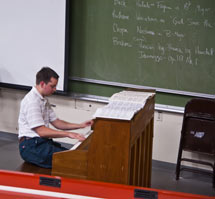 (Photo - Kyle Knoepfel plays the piano in Panofsky Auditorium)