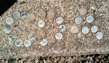 (Photo - pennies embedded in the sidewalk)